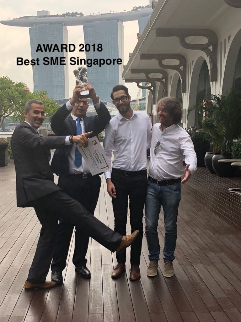 VIC award celebration in Singapore in 2018, with a trophy and certificate